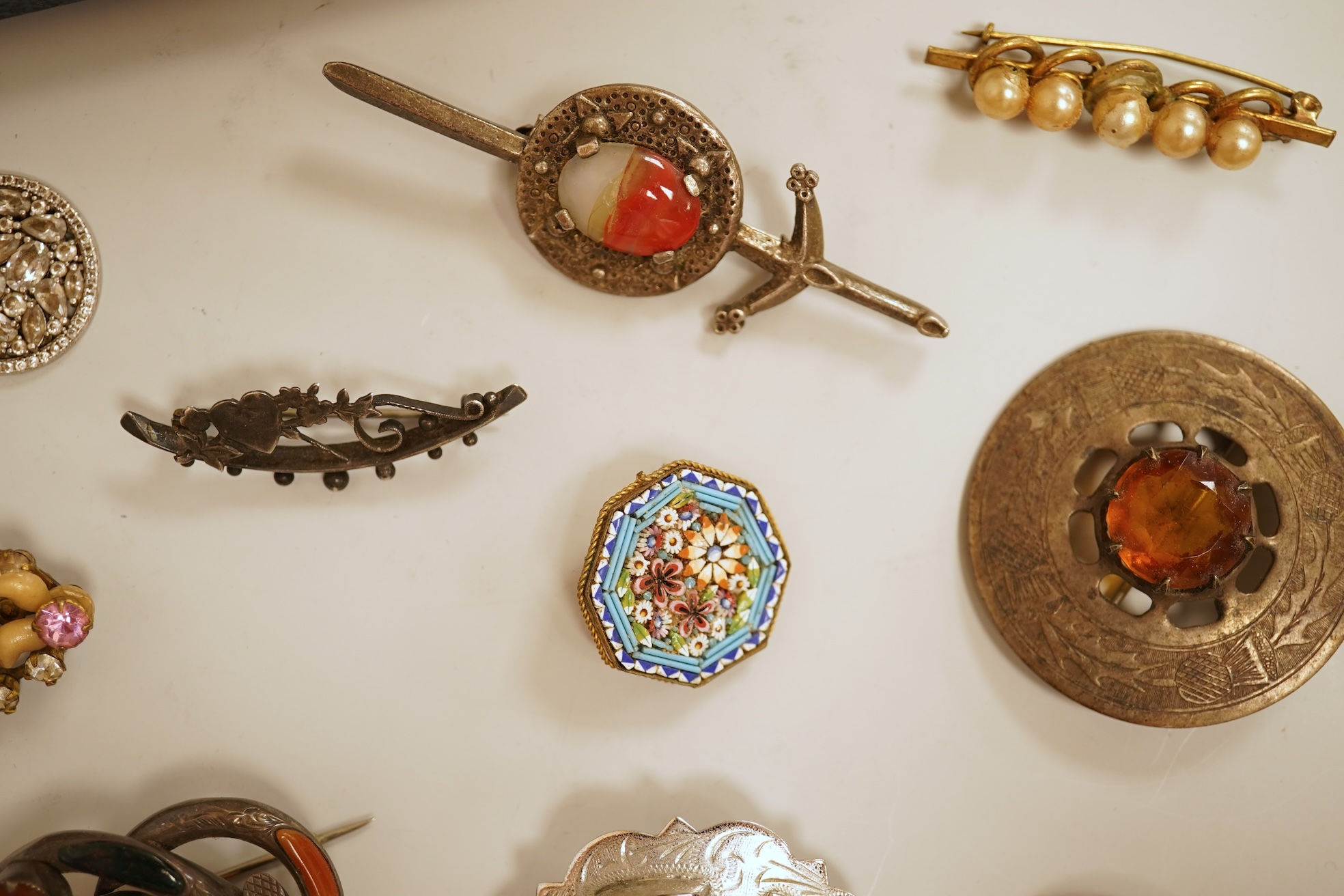 A small group of assorted jewellery including a gold plated curb link bracelet, silver brooch, simulated pearl necklace and costume.